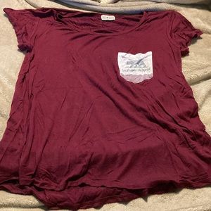 Burgundy Pocket Tee with Design on Pocket.